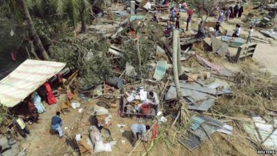 People retrieve their belongings from the wreckage after a tornado hit Bangladesh