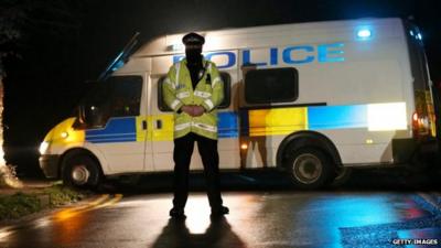 A police officer stands guard at a road block near to where it is believed Boris Berezovsky lived