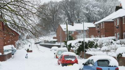 Cars are buried in deep snow in Mold, Flintshire, north Wales