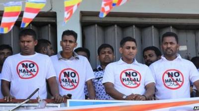 Sri Lanka’s hardline Buddhist group Bodhu Bala Sena members wear T- shirts urging boycott of consumer goods with Halal certification during a protest rally in Maharagama on the outskirts of Colombo, Sri Lanka, Sunday, Feb. 17, 2013