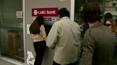 Cypriots waiting to withdraw cash from a cash machine