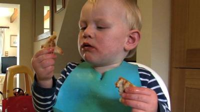 Young child holding food