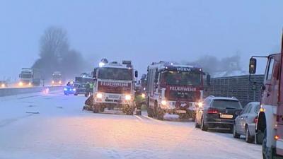 Lorries and cars on snowy road