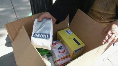 Woman with goods from food banks