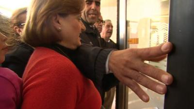 Cypriots queue to get into the reopened banks