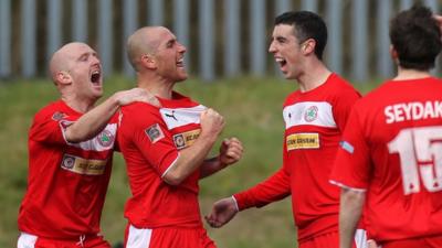 Cliftonville players celebrate with goal scorer Barry Johnston