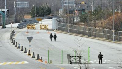 South Korean soldiers stand on the empty road