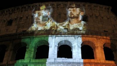 Pictures of Italian marines detained in India are projected together with the colours of the Italian flag on the Colosseum in Rome