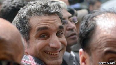 Egyptian satirist and television host Bassem Youssef is surrounded by his supporters upon his arrival at the public prosecutor's office in the high court in Cairo