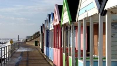 Colourful beach huts along a promenade