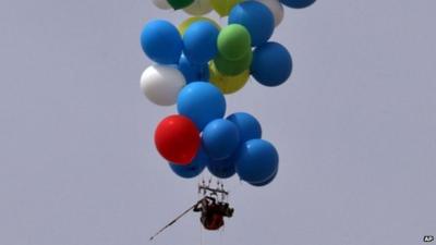 Man tied to balloons