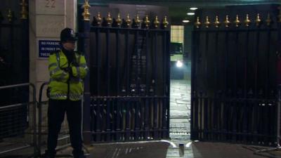 Policeman stands outside gates of Ritz