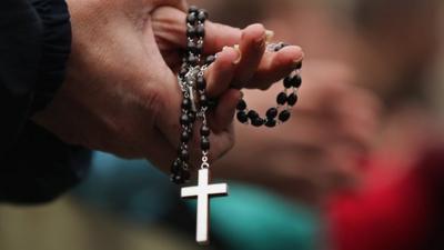 Crucifix being held in hands