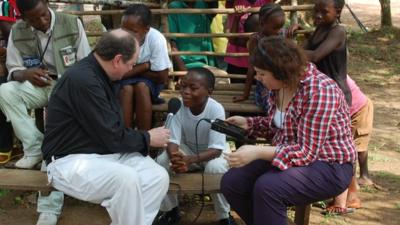 A young Liberian boy talks to James Naughtie