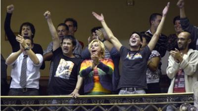 People celebrate in parliament after lawmakers voted to legalise gay marriage in Uruguay