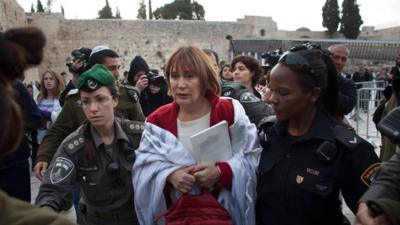 Israeli policewomen detain a member of the religious group "Women of the Wall"