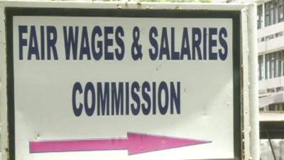 A sign reading Fair Wages & Salaries Commission