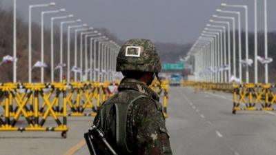 A South Korean soldier stands at a military check point connecting South and North Korea