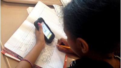 A schoolgirl using an iPod application to learn handwriting