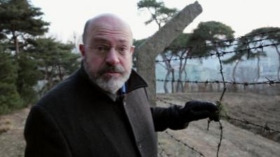 John Sweeney next to barbed wire fence