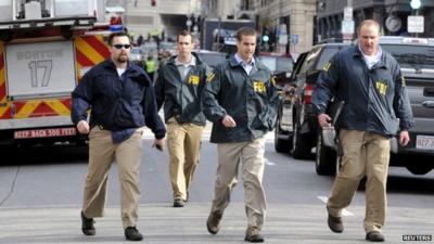 FBI agents arrive at the scene after explosions near the finish line of the Boston Marathon