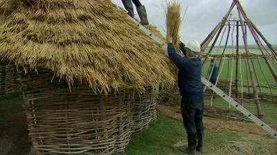 A replica Neolithic house under construction