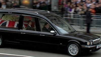 Hearse carrying coffin