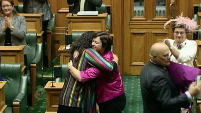 People hugging in New Zealand's parliament after it legalised gay marriage