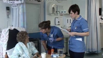 Nurses talking to a patient