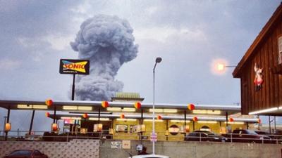 A plume of smoke rises from a fertilizer plant fire in West