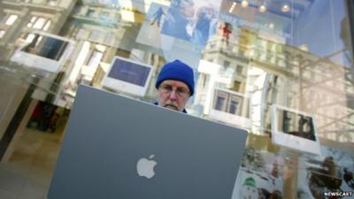 Customer logs onto a laptop while waiting for new Apple store in London to open