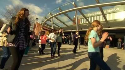 Dancers greeted the transport secretary at Derby Station.