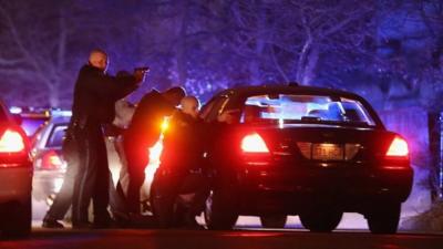 Police with guns drawn search for a suspect on April 19, 2013 in Watertown, Massachusetts