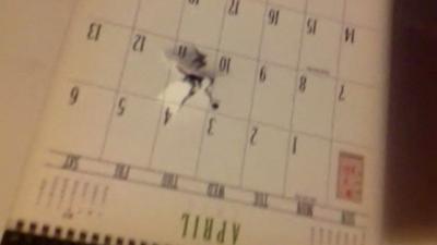 Bullet hole through student's calendar