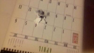 Bullet hole through student's calendar