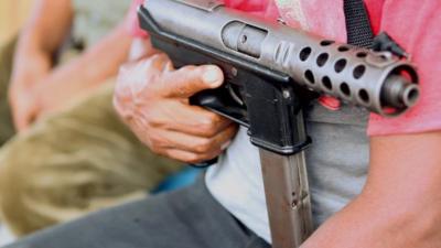 A gun held by a member of Ayulta's self-defence force