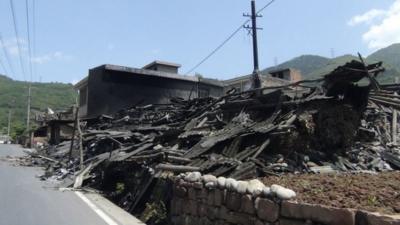 Collapsed houses are seen after an earthquake of 6.6 magnitud