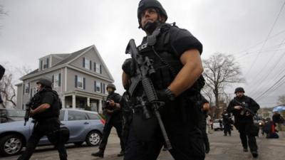 Police officers search house to house for Dzhokhar Tsarnaev