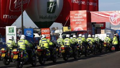 British police officers gather at the start at Blackheath during the London Marathon in London