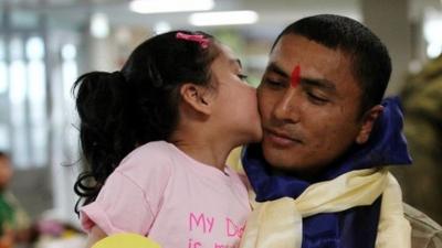 L/Cpl Kaushal Shahi is kissed by his five-year-old daughter Anouska