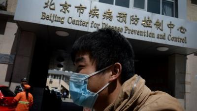 A Chinese man arrives at the Beijing Centre for Disease Prevention and Control as the country deals with the H7N9 bird flu virus