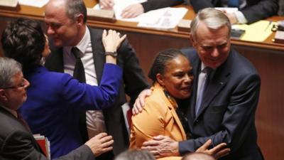 French Prime Minister Jean-Marc Ayrault hugs Justice Minister Christiane Taubira