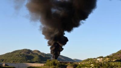 Smoke rises after shelling on al-Turkman mountains in the Latakia province, western Syria