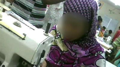 Secret film footage of child at sewing machine