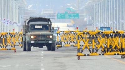 A South Korean military vehicle drives past barricades on the road leading to North Korea"s Kaesong industrial complex,