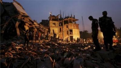 Bangladeshi soldiers stand in the rubble at the site of a building that collapsed in Savar, near Dhaka, Bangladesh