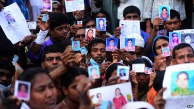 Bangladeshi relatives hold photos of the missing workers