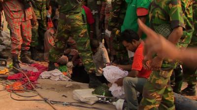 Rescuers pass oxygen and water to people who are trapped