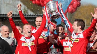 George McMullan and Chris Scannell lift the Gibson Cup