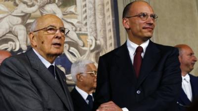 Italian Prime Minister-designate and deputy leader of the centre-left Democratic Party (PD) Enrico Letta (R) shakes hands with President Giorgio Napolitano at the Quirinale Palace in Rome on Saturday after the formation of a coalition government was announced